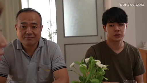 JAV · T-shirt · Living room · Medium shot · Sitting · Talking · Smirking · Potted plant