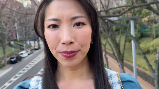 脸部特写 · 注视镜头 · 户外街道 · 正面站立 · 成熟女性 · 微带笑容 · 蓝色毛领上衣